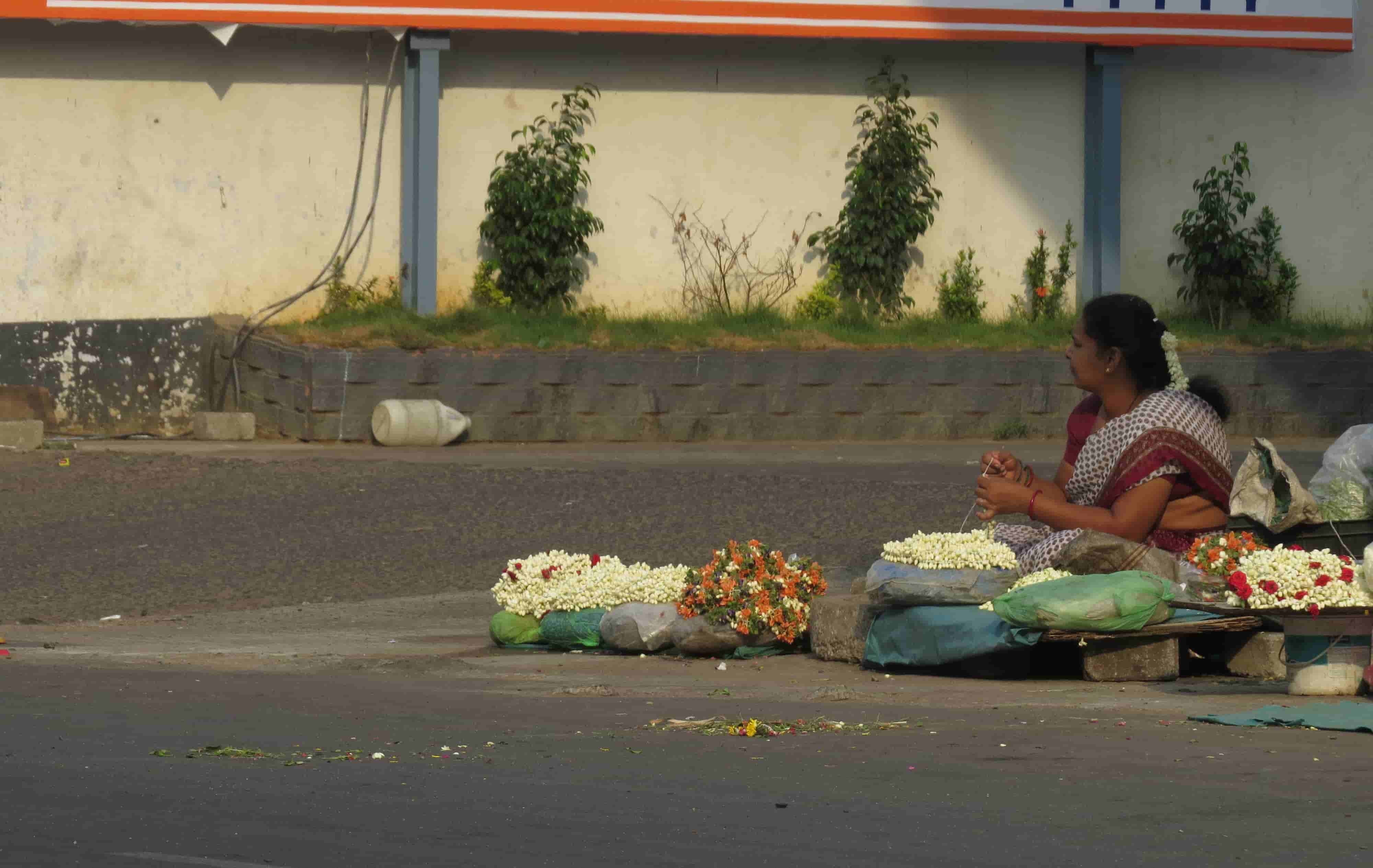 A woman sells flowers at a thoroughfare in Kodambakkam in the southern Indian state of Tamil Nadu.